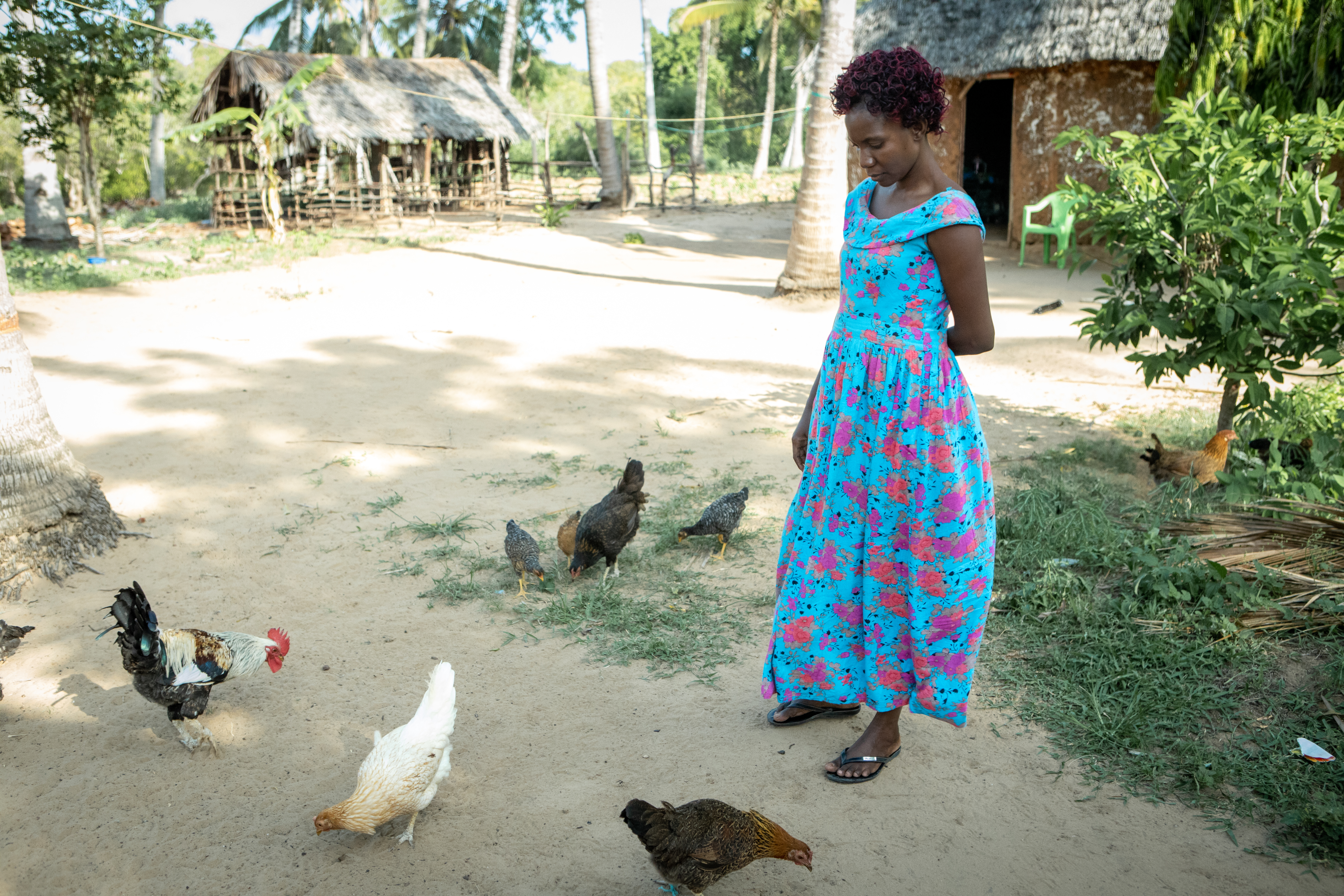 Josephine and her chicken at her home in Kilifi, Kenya