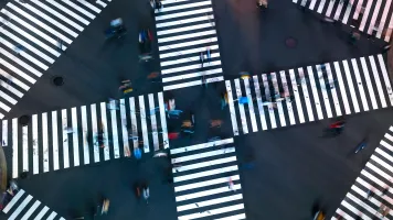 Traffic and people cross a busy intersection in Ginza, Tokyo. Credit: TierneyMJ/Shutterstock