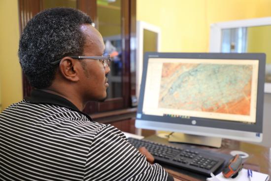 Abdirisak Aden, Head of GIS at the Puntland State Statistics Office examining the areas effected by Cylone Gati, Credit: Faaris Adam/GPSDD