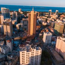 Aerial view of a city with the ocean in the background.