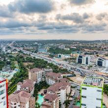 Aerial view of a city with clouds in the background.