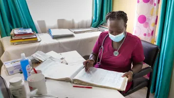 A medical consultant goes through records. Photo by: Elphas Ngugi/GPSDD