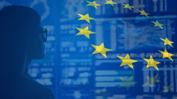 EU flag and map superimposed on photo of woman staring at data on a large screen. 