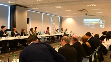 Group of people watching a presentation in a conference room