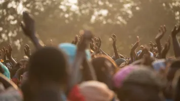 People with raised hands. Photo by Avel Chuklanov / Unsplash