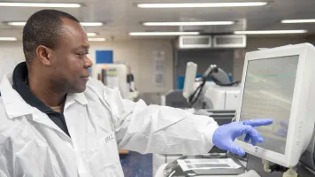 A Ghanaian, a laboratory technician assigned to hospital ship USNS Mercy, inputs and logs data samples in the ship’s laboratory in 2022. Investment is needed to improve data quality and availability. Copyright: Jake Greenberg (CC BY-NC 2.0)