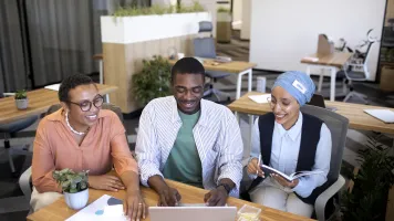 A diverse group of young professionals working collaboratively on data science