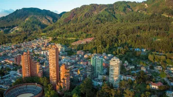 An aerial view of the center of Bogota, Colombia, with the Andes in the background. Photo by Jess Kraft, via Shutterstock