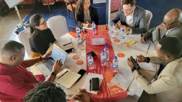 Partners from Colombia, Ghana, and Kenya in deep discussion during a MIDN peer exchange session