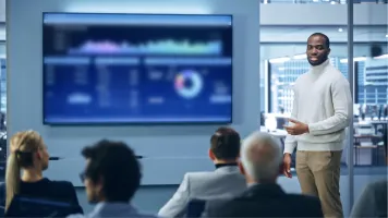 Image of a man presenting a data dashboard / Shutterstock