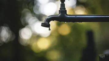Dripping tap - photo by Luis Tosta / Unsplash