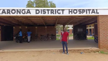 Steve Bowah CAN Fellow in front of a hospital