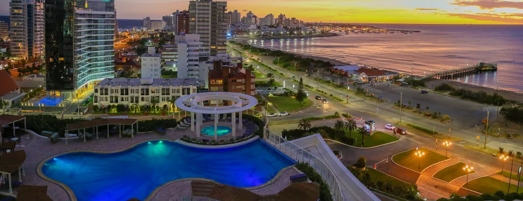 Cityscape at sunset along the coast.