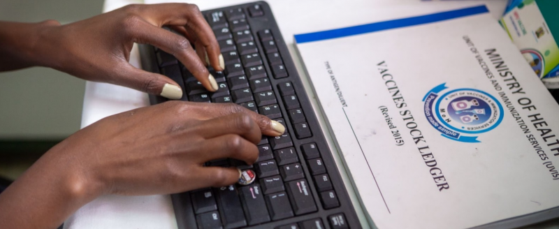 An attendant enters vaccination data on a computer at a clinic in Nairobi, Kenya.