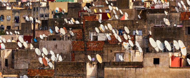Satellite dishes of parabolic antennas on building roofs of the old medina in Fes, Morocco. Credit: dsaprin via Shutterstock