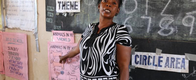 A teacher at her blackboard at the KDEC Pre-Primary School Masorie, Sierra Leone
