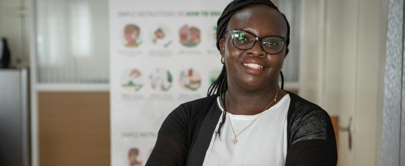 Dr. Evelyn Wesangula posing for a photo in a health office.