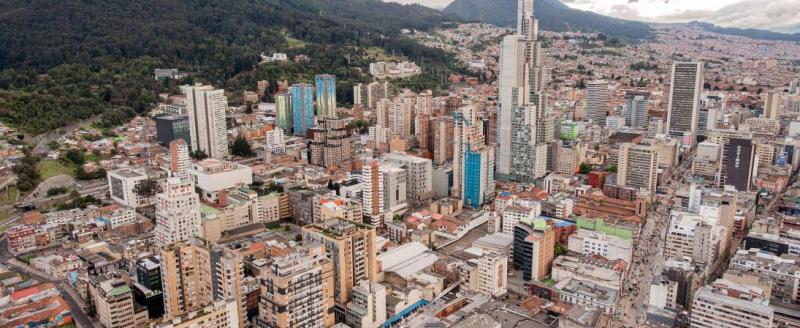 Buildings in the foreground with mountains in the background. Aerial view of Bogota, Colombia.