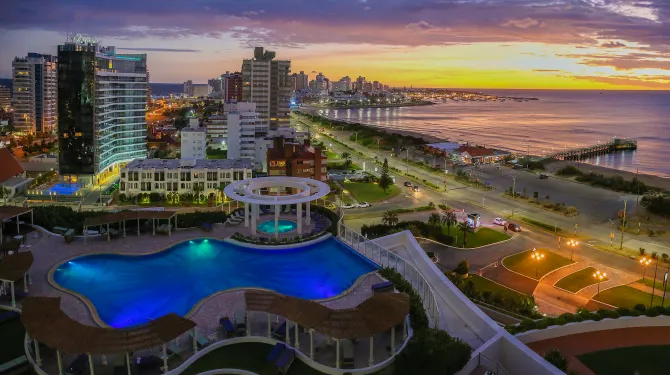 Aerial view of a city on the coast at sunset.