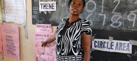 A teacher at her blackboard at the KDEC Pre-Primary School Masorie, Sierra Leone