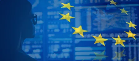 EU flag and map superimposed on photo of woman staring at data on a large screen. 
