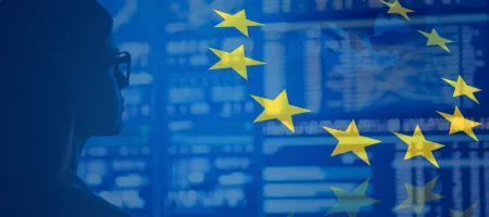 EU flag and map superimposed on photo of woman staring at data on a large screen. 