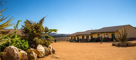 Wide angle shot houses built dry field few plants