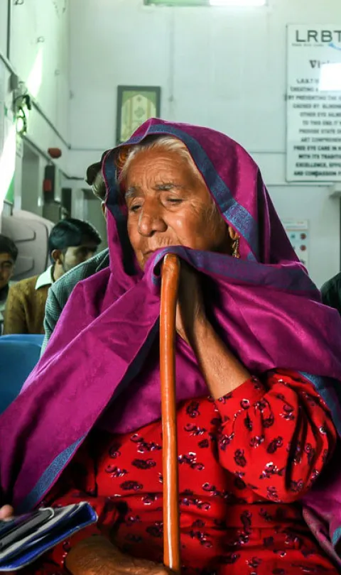 Naushad Bibi and her daughter-in-law talking to Muhammad Suleman (a data collector) at an eye hospital in Mandra, Pakistan. @Sightsavers/Jamshyd Masud.
