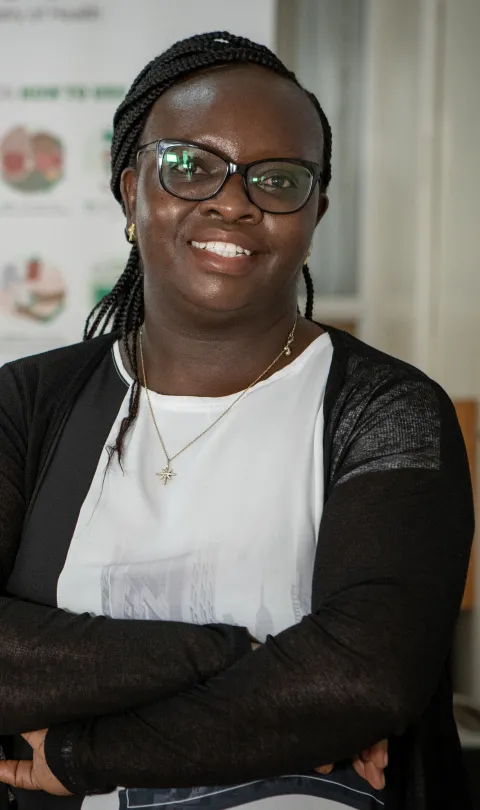 Dr. Evelyn Wesangula posing for a photo in a health office.