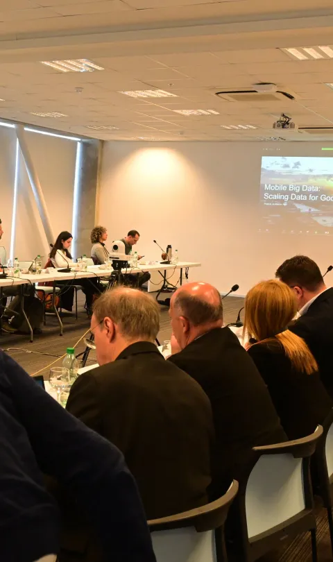 Group of people watching a presentation in a conference room