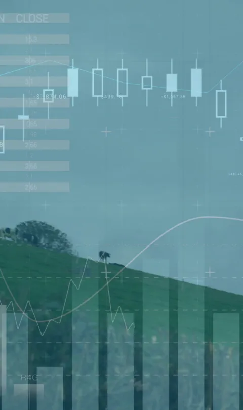 Image of wind turbines moving in countryside and stock exchange graph increasing and decreasing. Global environmental issues and development concept digitally generated image.