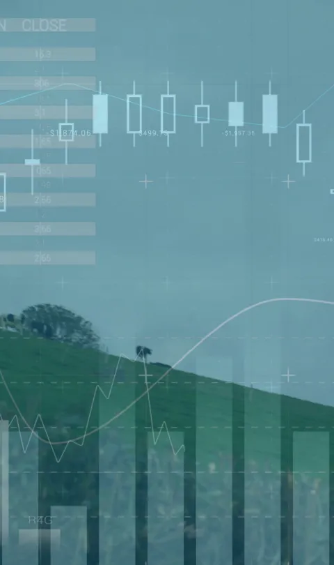 Image of wind turbines moving in countryside and stock exchange graph increasing and decreasing. Global environmental issues and development concept digitally generated image.