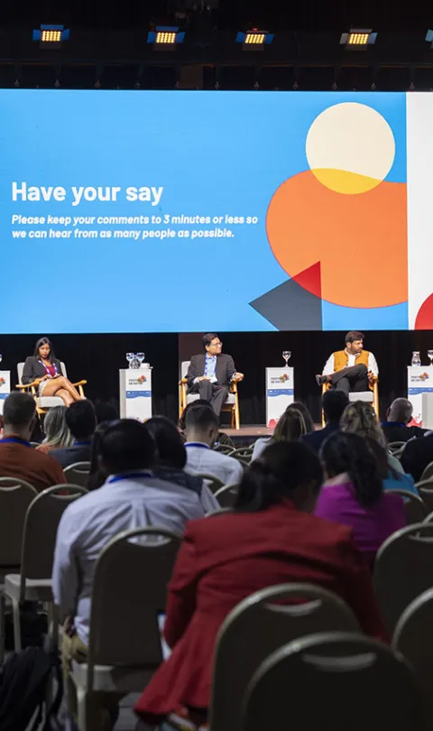 Five speakers on the stage in front of the audience for the AI town hall debate at Festival de Datos. A colourful slide in the background says: 'Have your say'. Photo by Nicolás Donatte