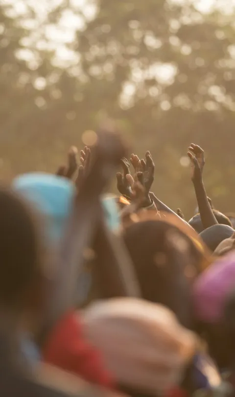 People with raised hands. Photo by Avel Chuklanov / Unsplash