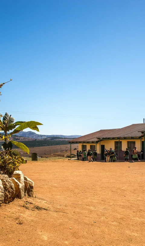 Wide angle shot houses built dry field few plants