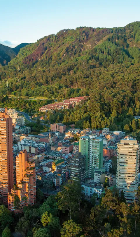 An aerial view of the center of Bogota, Colombia, with the Andes in the background. Photo by Jess Kraft, via Shutterstock