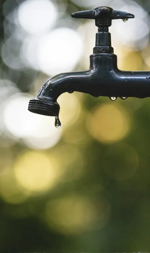 Dripping tap - photo by Luis Tosta / Unsplash