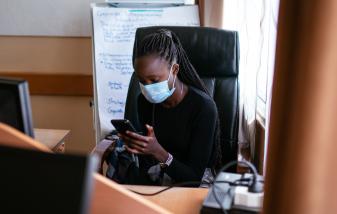 Kenyan woman looking at her phone
